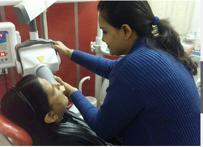 Doctor checking patient at Astha Dental